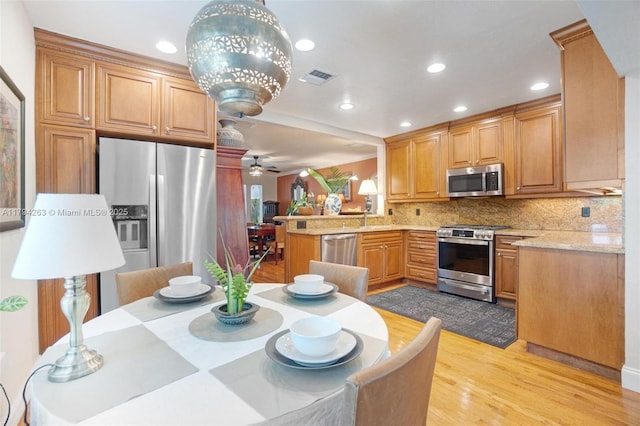 kitchen featuring visible vents, decorative backsplash, light wood-type flooring, recessed lighting, and stainless steel appliances