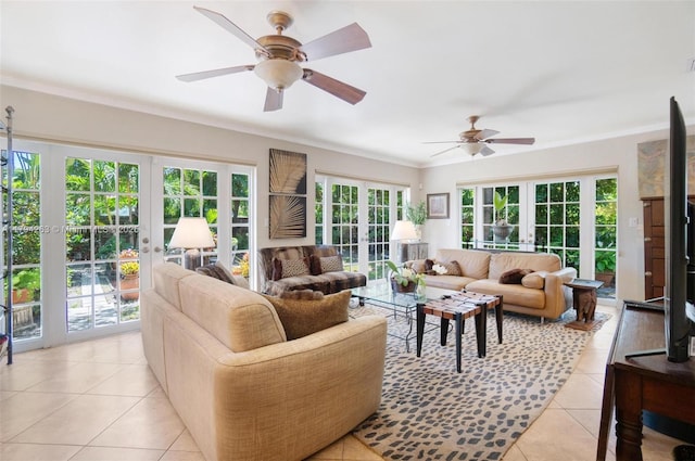 living room with french doors, a ceiling fan, crown molding, and light tile patterned flooring