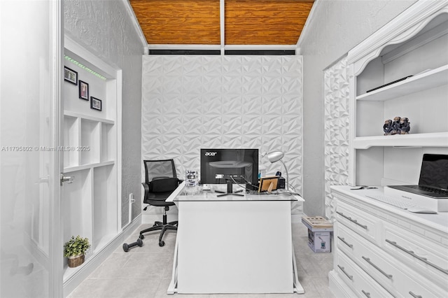 office area with light tile patterned flooring and a textured wall
