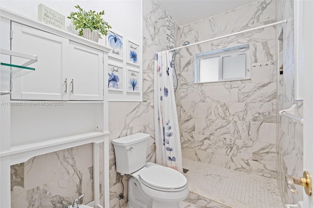 full bathroom featuring toilet, marble finish floor, and a stall shower
