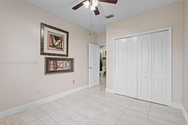 unfurnished bedroom featuring visible vents, a ceiling fan, baseboards, and a closet