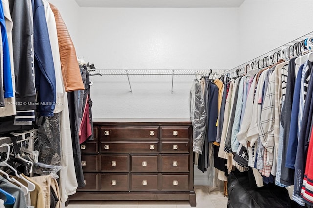 walk in closet with light tile patterned flooring
