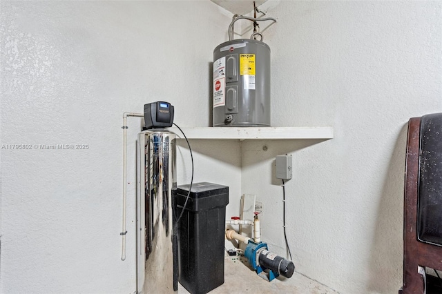 interior details featuring a textured wall and water heater