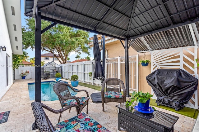view of patio featuring outdoor lounge area, a gazebo, a fenced in pool, and a fenced backyard