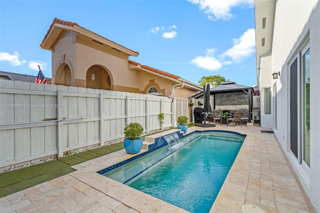 view of swimming pool featuring a fenced backyard, a fenced in pool, a gazebo, and a patio area