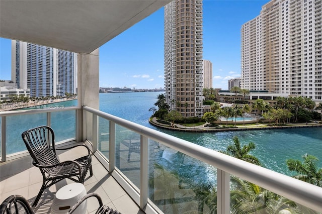 balcony with a water view and a city view