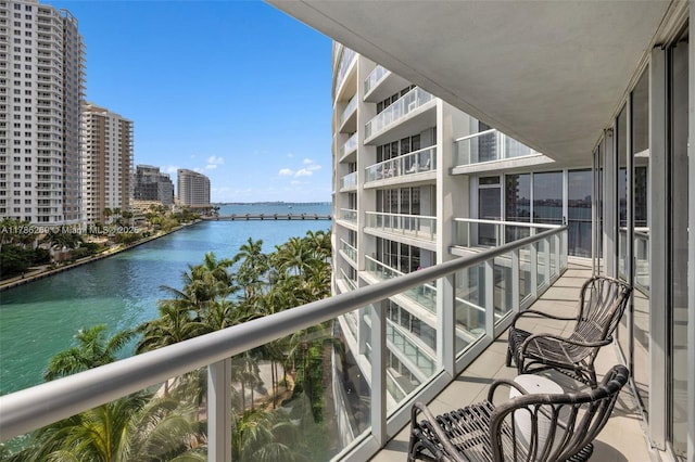 balcony featuring a water view and a view of city