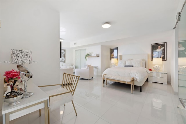 bedroom with baseboards, visible vents, and light tile patterned floors