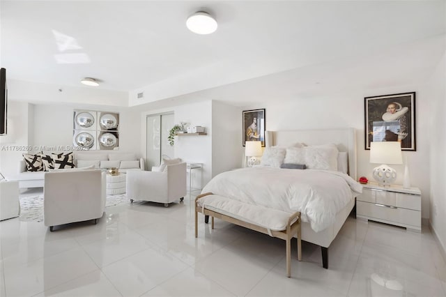 bedroom with light tile patterned floors, baseboards, a closet, and visible vents