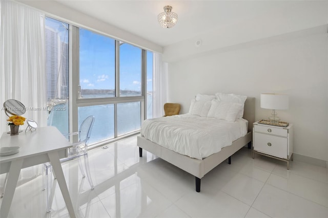 bedroom featuring light tile patterned flooring, baseboards, and multiple windows