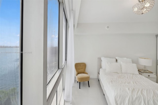 bedroom with light tile patterned floors and multiple windows