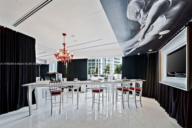 dining room with tile patterned floors and a notable chandelier