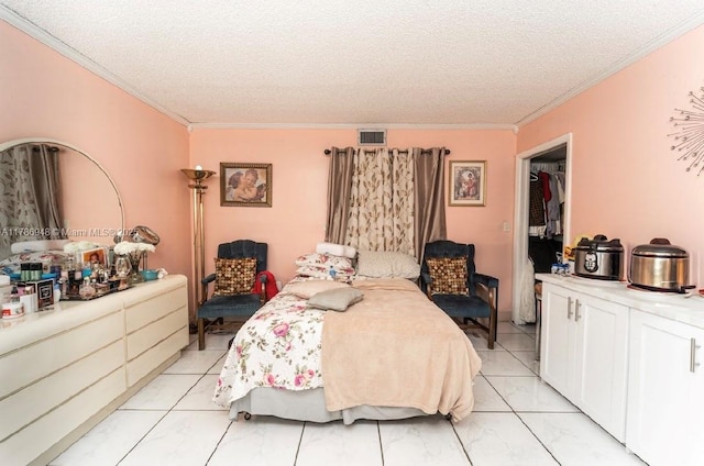 bedroom with crown molding, a textured ceiling, and visible vents