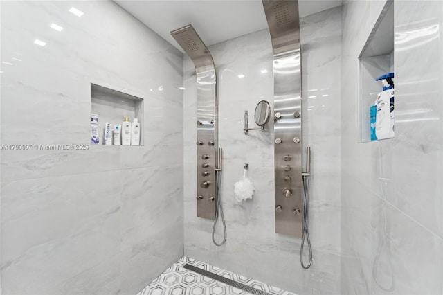 full bath featuring a marble finish shower and tile patterned floors