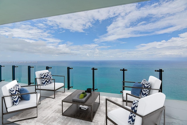 view of patio featuring a water view, a balcony, and an outdoor hangout area