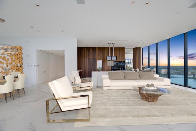 living area with expansive windows, marble finish floor, and plenty of natural light