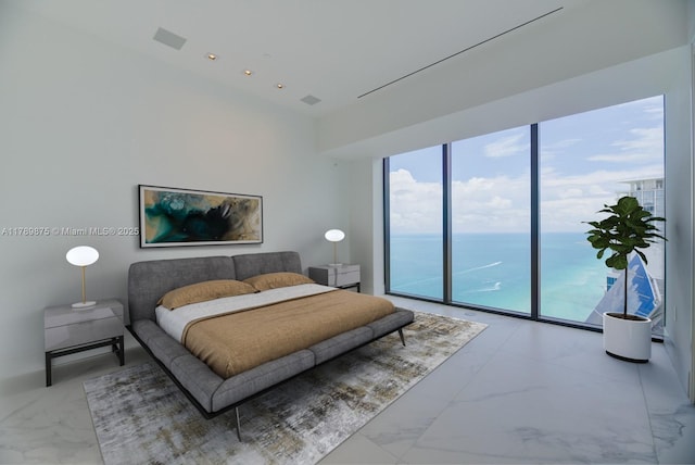 bedroom with marble finish floor and access to exterior
