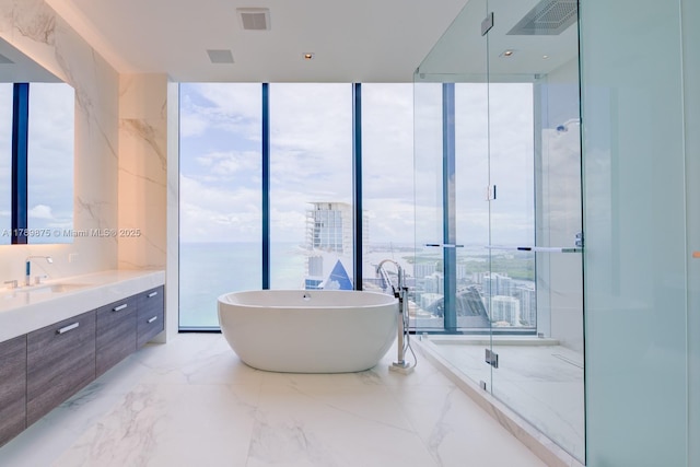 full bath with vanity, marble finish floor, an enclosed shower, visible vents, and a soaking tub