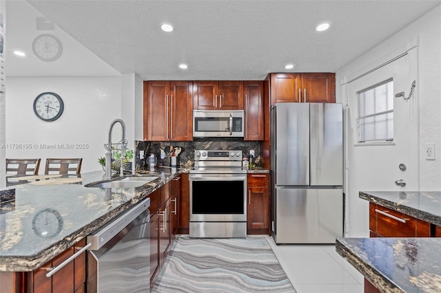 301 NE 14th Ave Unit 207, Hallandale Beach, FL 33009 - kitchen featuring appliances with stainless steel finishes, a sink, a peninsula, dark stone countertops, and recessed lighting