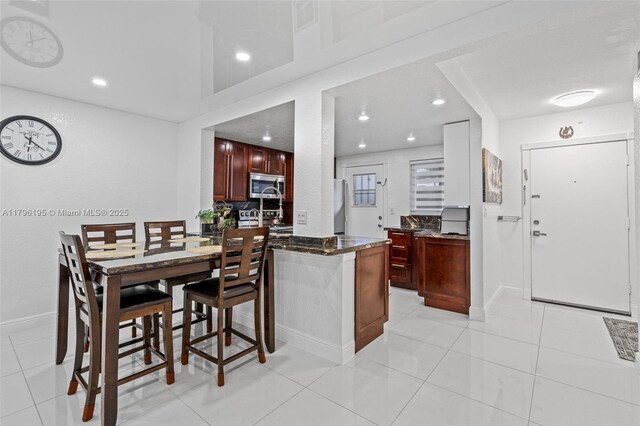 301 NE 14th Ave Unit 207, Hallandale Beach, FL 33009 - dining area with recessed lighting and light tile patterned floors