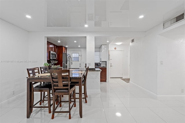 301 NE 14th Ave Unit 207, Hallandale Beach, FL 33009 - dining area with baseboards, recessed lighting, and light tile patterned floors