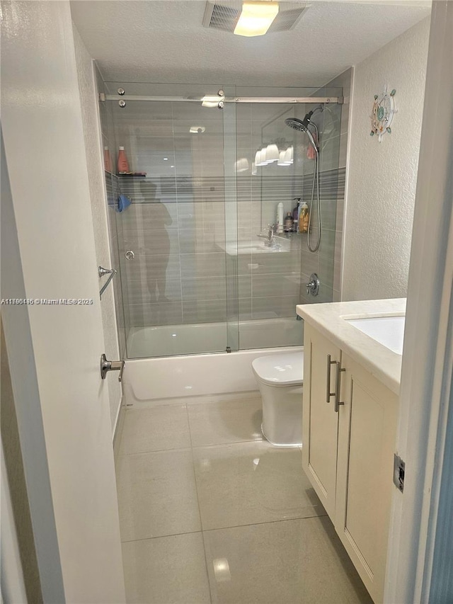 full bath with a textured wall, tile patterned flooring, toilet, combined bath / shower with glass door, and visible vents