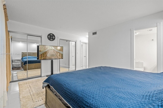 301 NE 14th Ave Unit 207, Hallandale Beach, FL 33009 - tiled bedroom featuring multiple closets