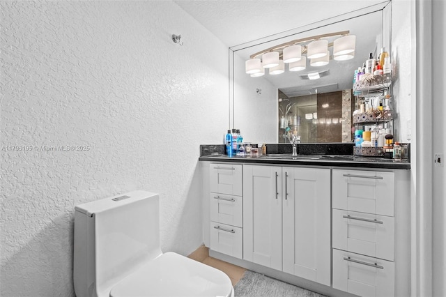 301 NE 14th Ave Unit 207, Hallandale Beach, FL 33009 - bathroom with a textured wall, vanity, and toilet