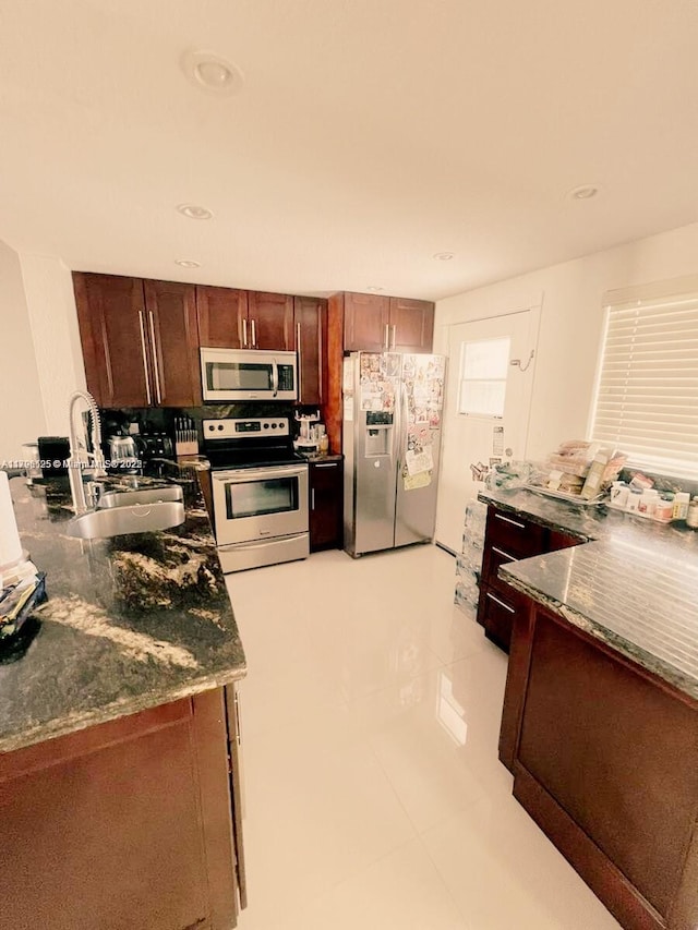 kitchen featuring light tile patterned flooring, appliances with stainless steel finishes, a sink, and recessed lighting