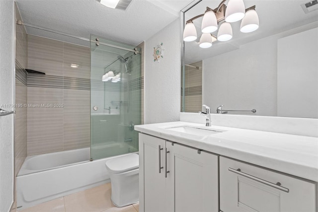 301 NE 14th Ave Unit 207, Hallandale Beach, FL 33009 - bathroom with toilet, enclosed tub / shower combo, vanity, tile patterned floors, and a textured ceiling