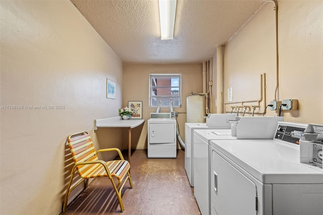 301 NE 14th Ave Unit 207, Hallandale Beach, FL 33009 - communal laundry room featuring washer and dryer and a textured ceiling