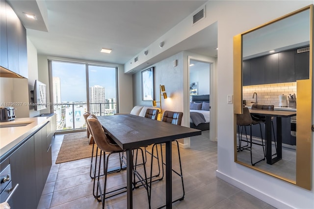 dining space featuring tile patterned flooring, visible vents, and a wealth of natural light
