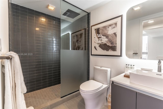 bathroom featuring vanity, walk in shower, toilet, and visible vents