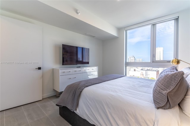 bedroom with visible vents and light tile patterned floors