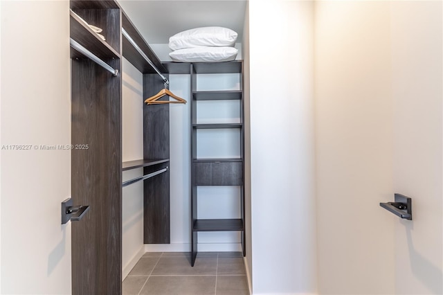spacious closet featuring light tile patterned floors