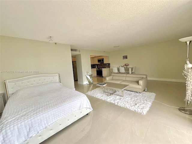 bedroom with baseboards, a textured ceiling, light tile patterned floors, and visible vents