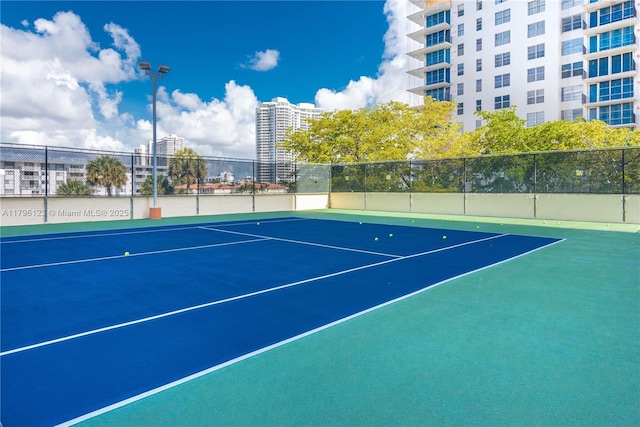 view of sport court with fence