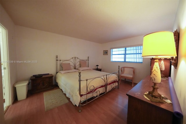 bedroom with wood finished floors
