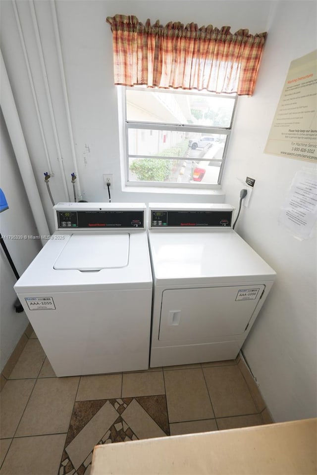 laundry room featuring independent washer and dryer and light tile patterned floors