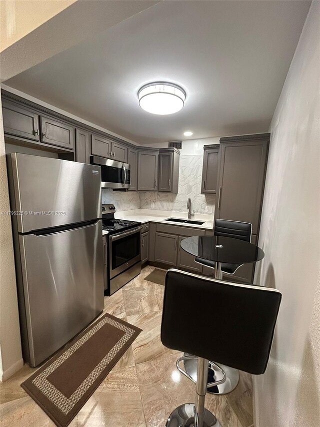 850 SW 133rd Ter Unit 312B, Pembroke Pines, FL 33027 - kitchen with stainless steel appliances, decorative backsplash, a sink, and light countertops