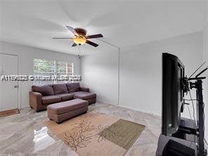 living area featuring ceiling fan