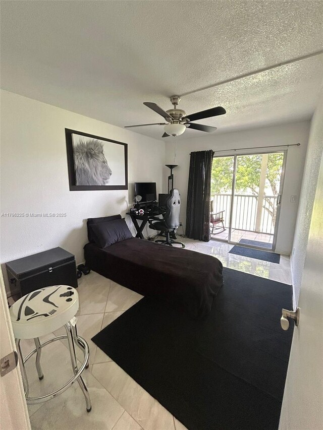 850 SW 133rd Ter Unit 312B, Pembroke Pines, FL 33027 - bedroom featuring access to exterior, tile patterned floors, ceiling fan, a textured ceiling, and a desk