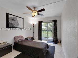 bedroom featuring access to outside, ceiling fan, and tile patterned flooring