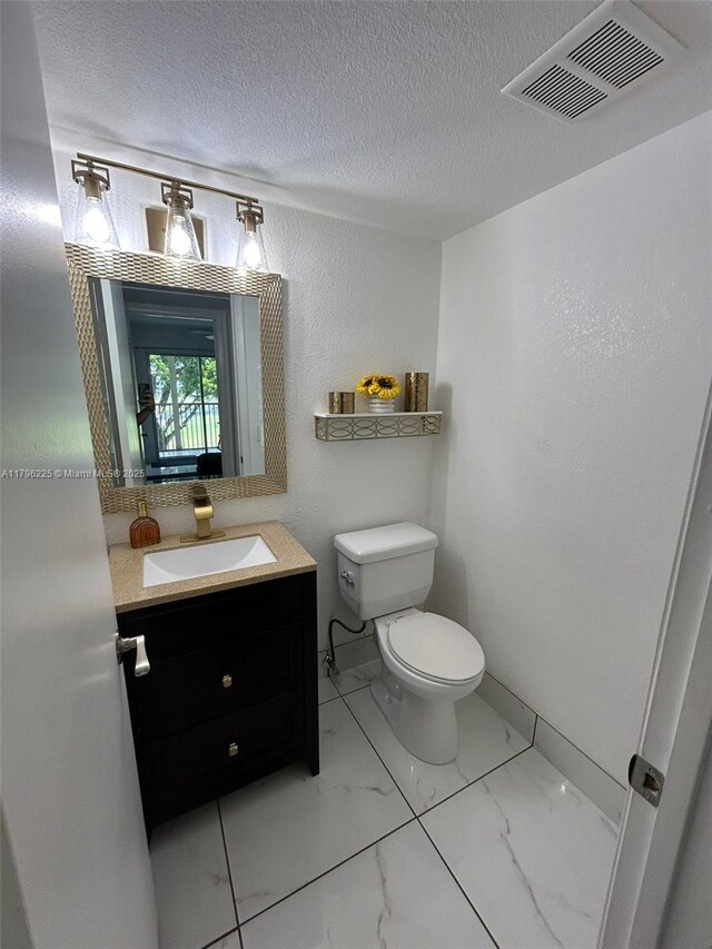 850 SW 133rd Ter Unit 312B, Pembroke Pines, FL 33027 - half bath with toilet, vanity, a textured ceiling, and marble finish floors