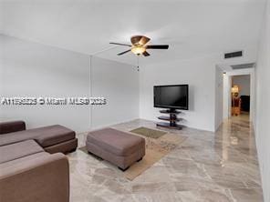 living room with visible vents, a ceiling fan, and marble finish floor
