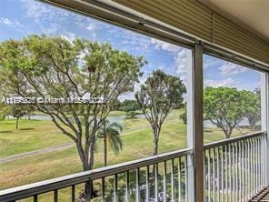 balcony with a water view and golf course view