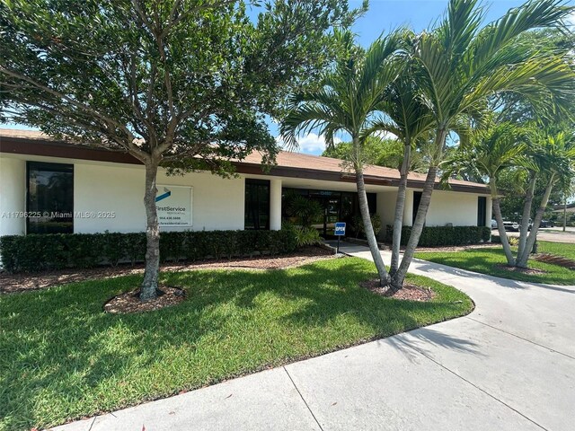 850 SW 133rd Ter Unit 312B, Pembroke Pines, FL 33027 - view of front of house featuring a front lawn, stucco siding, a carport, and driveway