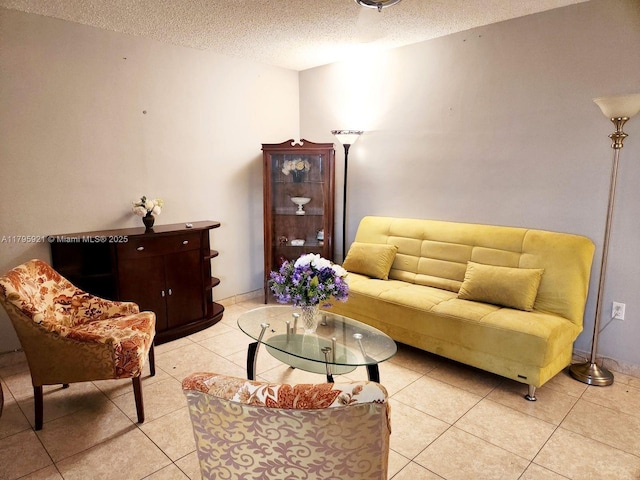living area with light tile patterned floors and a textured ceiling