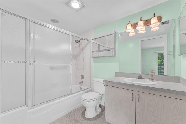 full bath with tile patterned flooring, vanity, toilet, visible vents, and bath / shower combo with glass door