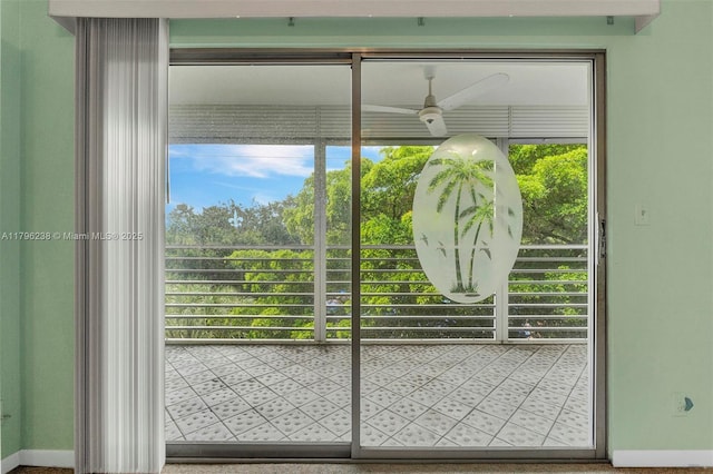 doorway featuring plenty of natural light, baseboards, and ceiling fan